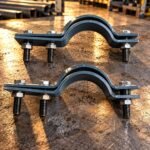 Split pipe clamps showing paired curved halves and side bolt positions